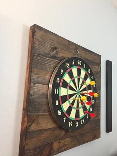 a wooden wall mounted with a dart on it