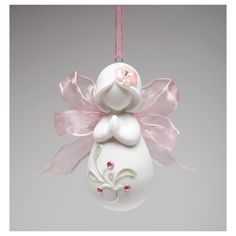 a white ornament hanging from a pink ribbon