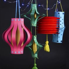 several colorful paper lanterns hanging from strings with string lights on the top and bottom of them