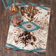 a brown and white rug sitting on top of a wooden floor next to a chair