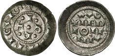 an old silver coin with ornate designs on it