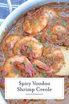 spicy voodoo shrimp crocke in a white bowl with a wooden spoon on the side