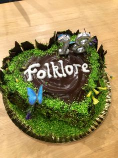 there is a cake that says folklore on the top and green grass in the middle