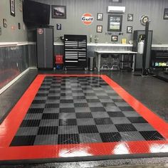 a checkered floor in a garage with tools on it and other workbenches