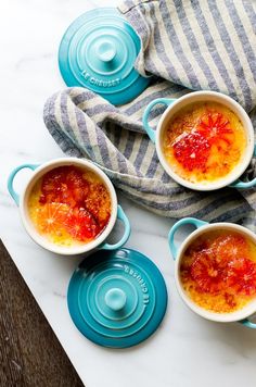 four small bowls filled with food on top of a table