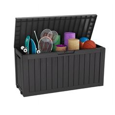 a large storage box filled with assorted sports equipment and balls on top of it