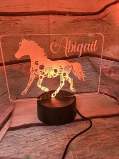 a lamp with a horse on it and the word abigai above it is an image of a running horse