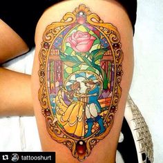 a woman with a tattoo on her thigh that has an image of beauty and the beast in it