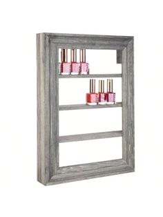 a wooden shelf with four bottles on it and one in the middle is filled with pink nail polish