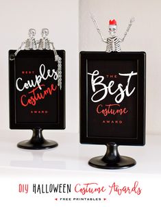 two black and white signs with the words best costume awards written on them in red lettering