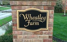 a black and gold sign that says wheatley farm