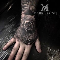 a man's hand with a bear on it and the words marked one written in black ink