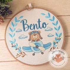 a teddy bear is sitting on top of an airplane with the word bento in it