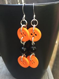 Orange buttons make quite a statement on these one of a kind earrings. The black beads give them a kind of Halloween look. I love the combination of colors, a great pair for the autumn season. These button earrings can also be a celebration of the University of Tennessee. These earrings hang around 2 inches on silver plated french hooks. Check out these beauties.... https://www.etsy.com/listing/217978155/on-fire-beaded-dangle-earrings-bead?ref=shop_home_active_19 Edgy Handmade Earrings For Halloween, Edgy Handmade Halloween Earrings, Handmade Spooky Black Earrings, Handmade Black Halloween Earrings, Unique Black Nickel-free Plug Earrings, Halloween Earrings Diy, Earrings Button, Earrings Edgy, Earrings Bead