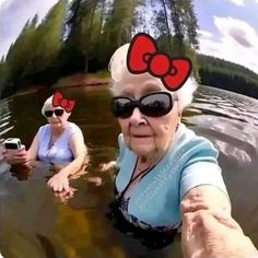 an old woman wearing sunglasses and a bow is in the water with two other women