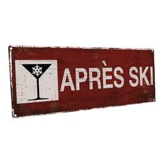 a wooden sign that says apres ski with a martini in the glass on it