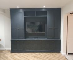 a large entertainment center with built in cabinets