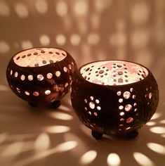 two brown vases sitting next to each other on a white surface with light shining through them