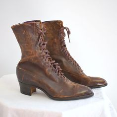 "Antique Edwardian/Victorian brown leather lace up boots.  The leather is so soft and supple -- there is no cracking or tearing; the leather just has marks and surface scuffs (no gouges).  The leather soles are in excellent condition, with very little wear, other than some sticker residue.  The tops of the inside lining is purple satin, and it is starting to shred some.  The rest of the lining is a cotton canvas.  The heels are stacked wood, and are around 1 3/4\" tall.  The boots are 10\" from Orphan Boots, Victorian Leather Boots, Brown Victorian Boots, 1950 Boots, Vintage Boots Aesthetic, Vintage Lace-up Boots With Leather Sole For Fall, Vintage Leather Sole Lace-up Boots For Fall, Vintage Lace-up Boots With Snip Toe And Leather Sole, Fitted Brown Lace-up Boots With Closed Toe