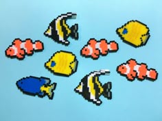 several different types of pixelated fish on a blue surface