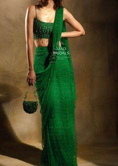 Elevate your style with our exquisite handcrafted emerald green saree--a masterpiece in pure premium net. Impeccably adorned with pearls and intricate hand embellishments, this ensemble exudes timeless elegance. Picture yourself in a perfectly tailored blouse, crafted to your measurements, paired seamlessly with a pre-stitched saree for effortless draping. Unveiling the Details: Color: Emerald Green Craftsmanship: Masterful Handwork Fabric: Luxurious Pure Premium Net **Important Notes All our items are meticulously handmade and uniquely tailored for our valued customers. Expect minor variations in the actual product compared to the displayed image. Product color may slightly vary due to photographic lighting sources or your monitor settings. Please be advised that once an order is placed, Red Saree Bridal, Cocktail Saree, Handmade Saree, Saree Red, Drape Sarees, Draped Saree, Indian Fashion Trends, Saree Designer, Indian Designer Sarees