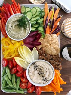 a platter filled with vegetables and dips