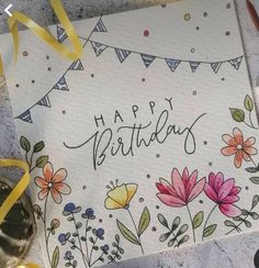 a happy birthday card with flowers and buntings on it, surrounded by confetti