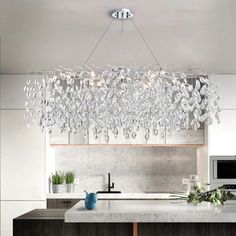 a modern chandelier hanging over a kitchen island