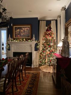 a dining room with a christmas tree in the corner