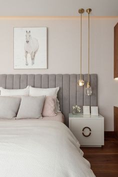 a bedroom with a bed, nightstands and pictures on the wall above it that has a horse drawn on the wall