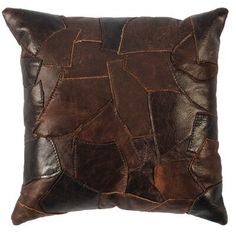 a brown leather pillow with patches on it's sides and a white back ground