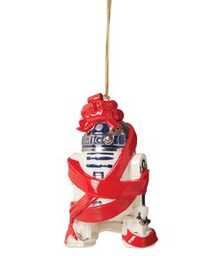 an ornament shaped like a robot with a red ribbon around it's neck