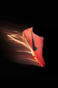 a pair of shoes with fire coming out of the soles on a black background