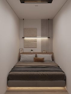 a bed sitting in the middle of a bedroom next to a wall mounted light above it