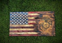 an american flag made out of pallet wood with the us marine emblem on it