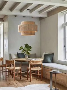 a dining room with wooden floors and white walls