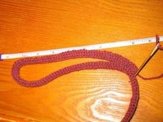 a crocheted leash with a measuring tape on it