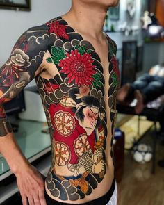 a man with tattoos on his chest and arms