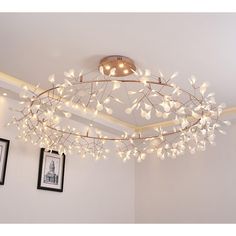 a chandelier with white flowers hanging from the ceiling