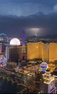 an aerial view of the las vegas strip at night with lightning in the sky above