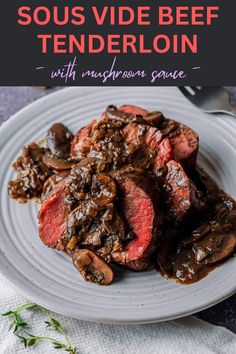 steak with mushroom sauce served on a white plate and garnished with fresh herbs