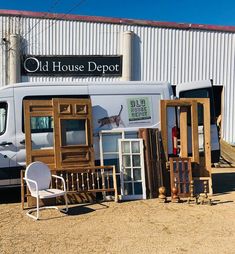 an old house depot with chairs and other items in front of the van that is parked next to it