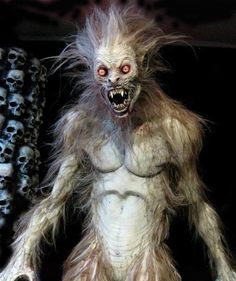 a creepy looking creature with long hair and big teeth