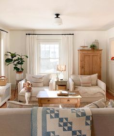 a living room filled with furniture and a window