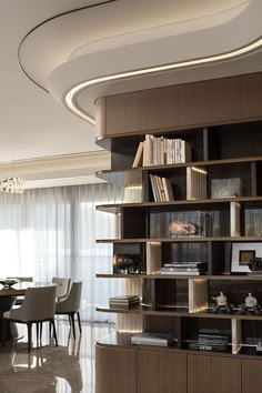 a dining room table with chairs and bookshelves