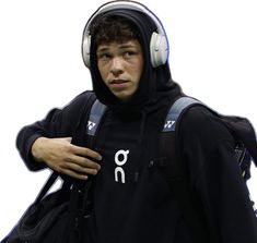 a young man wearing headphones and a backpack