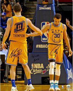 two basketball players shaking hands on the court