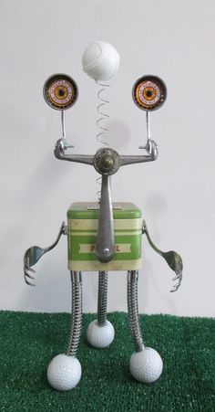 a metal robot with two golf balls on its head