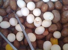 potatoes and corn on the cob with tongs laying next to eachother