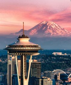 the space needle in seattle, with mt rainier in the background